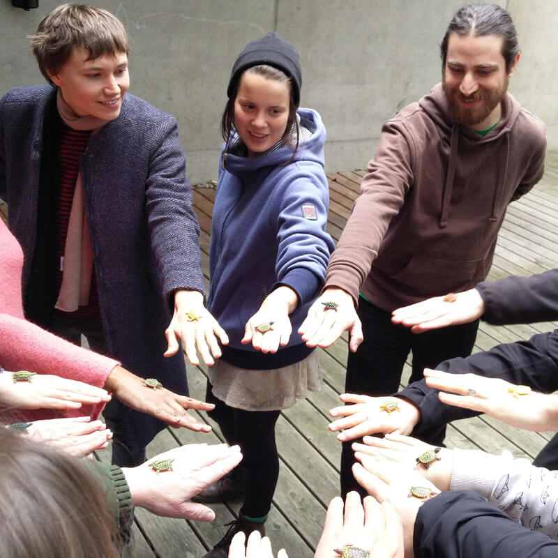 more onion team standing in a circle with hands in the middle